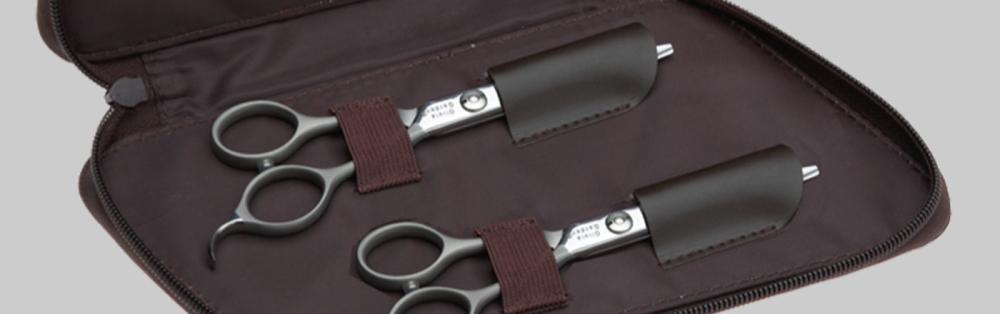 two hair scissors in a case for display