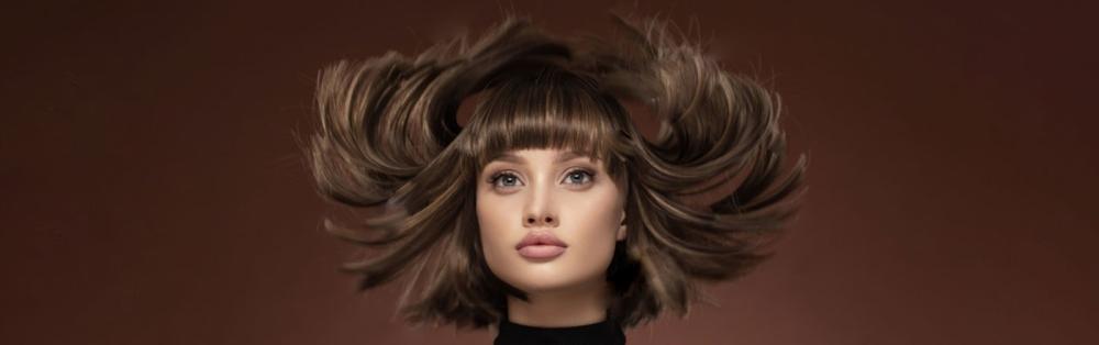  Woman's hair is blown by hair dryer for hairdressing