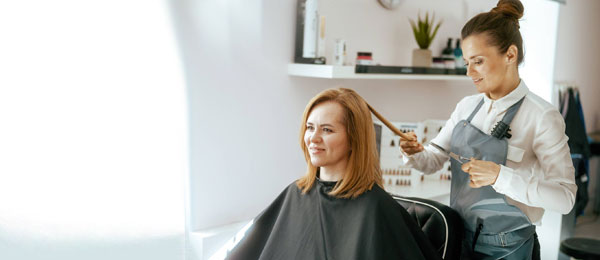 hairdresser preparing customer's hair