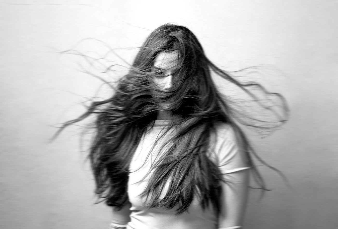 blurred image of a girl looking throught hair hair